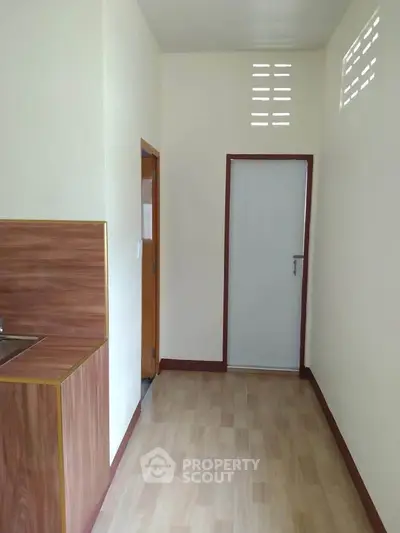 Compact kitchen space with wooden accents and closed layout