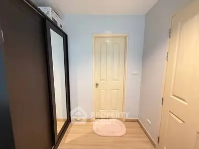 Cozy bedroom corner with wardrobe and light wooden flooring