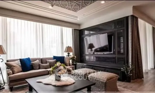 Luxurious living room with elegant decor and large windows, perfect for relaxation and entertainment.