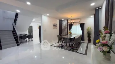 Spacious modern dining area with elegant decor and open layout, perfect for entertaining guests.
