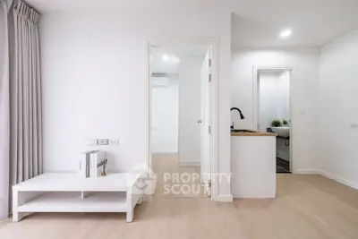 Modern minimalist apartment interior with open layout and light wood flooring.