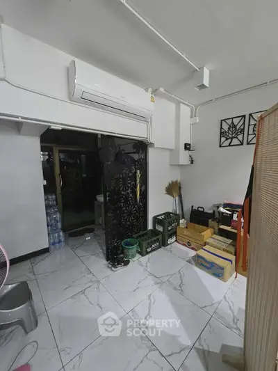 Spacious storage area with air conditioning and organized boxes, ideal for efficient home organization.