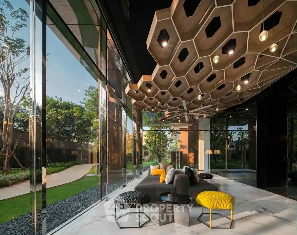 Luxurious modern living room with unique ceiling design and large glass windows overlooking a lush garden.