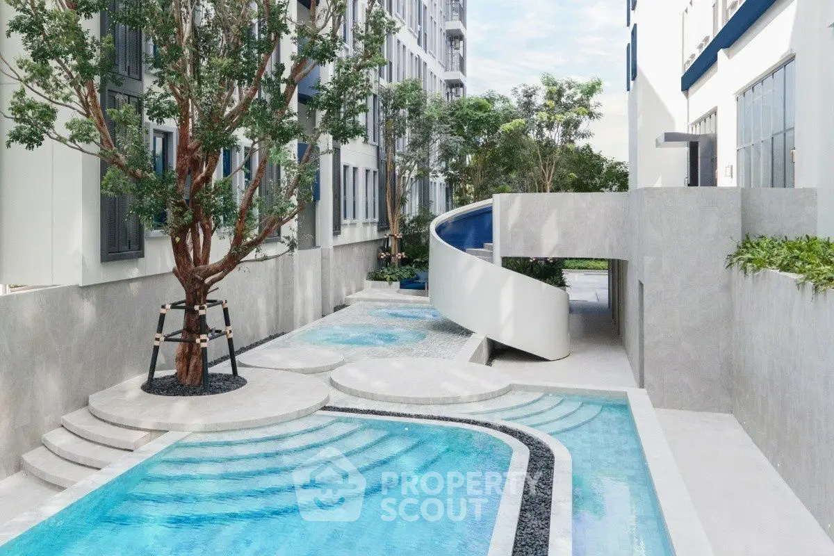 Modern apartment complex with stylish pool and lush greenery