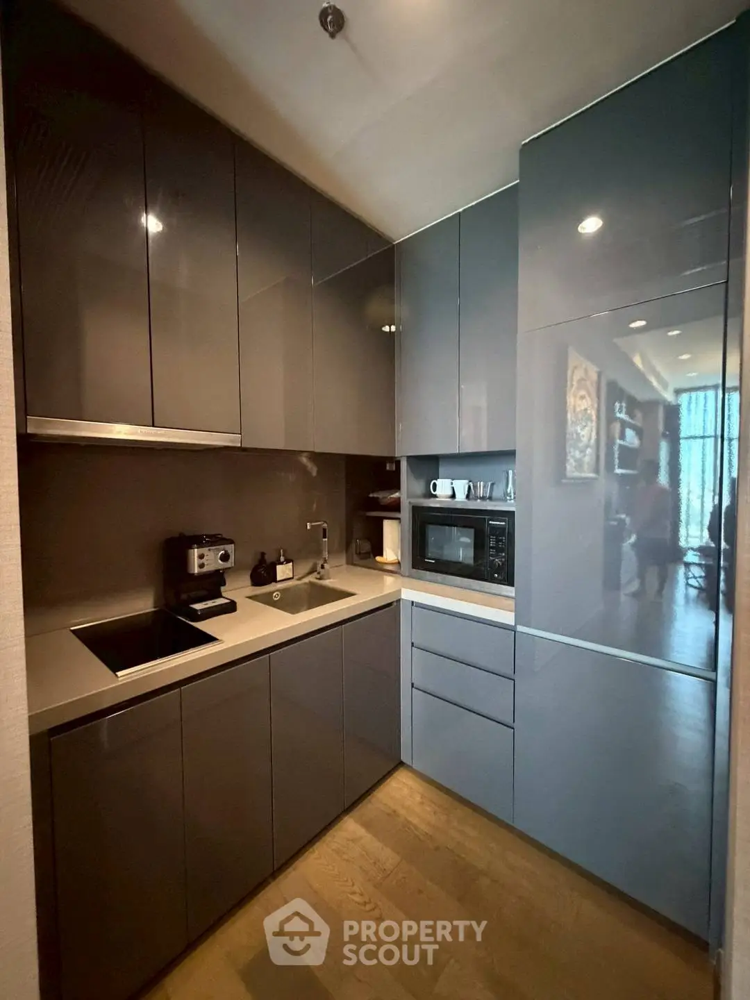 Modern kitchen with sleek cabinetry and built-in appliances in a compact layout.