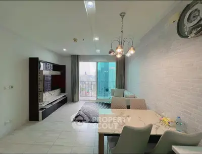 Modern living room with city view, stylish furniture, and elegant lighting in a high-rise apartment.