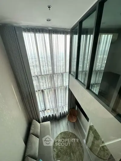 Stunning high-rise living room with floor-to-ceiling windows and panoramic city views.