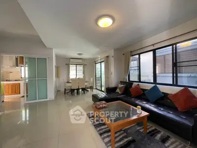 Spacious living room with modern decor and natural light in a stylish apartment.