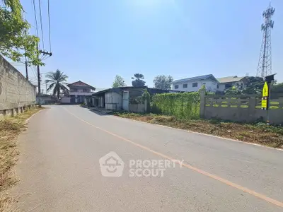 Charming suburban street view with residential houses and lush greenery, perfect for peaceful living.