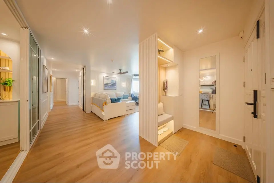 Spacious modern living room with wooden flooring and cozy seating area