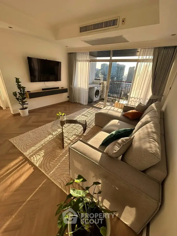 Luxurious living room with modern decor and stunning city view from the balcony.