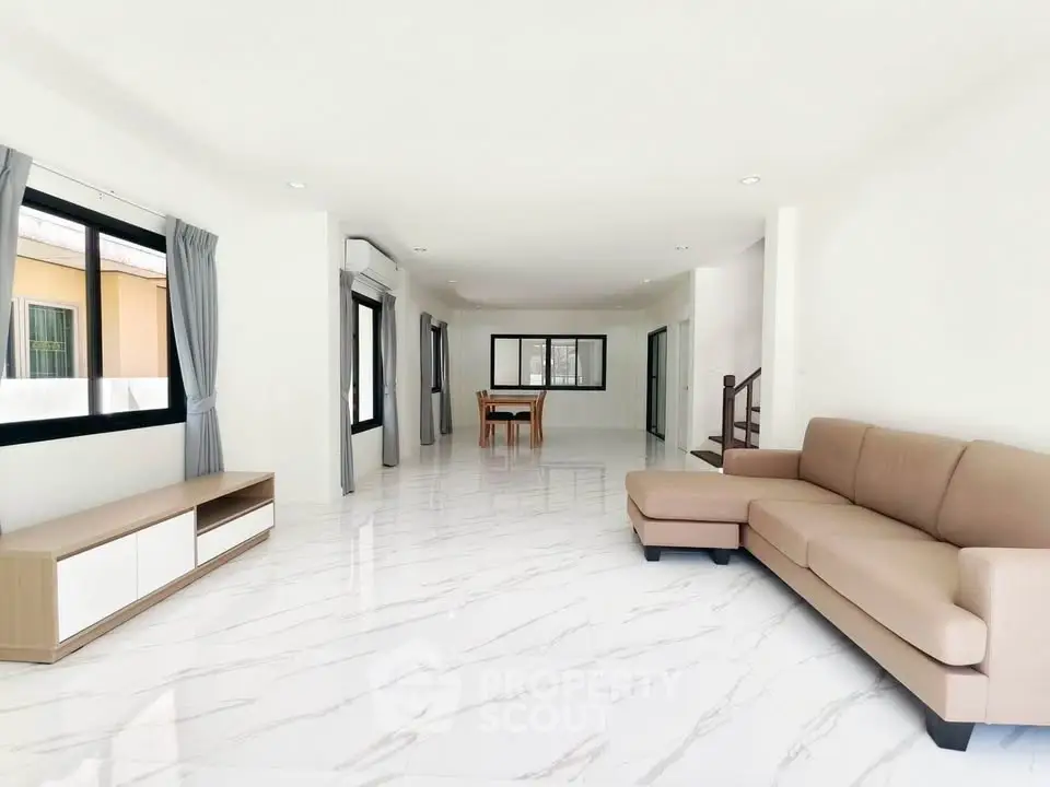 Spacious modern living room with sleek marble flooring and elegant furniture