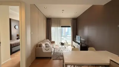 Modern living room with city view, cozy sofa, and dining area in stylish apartment.