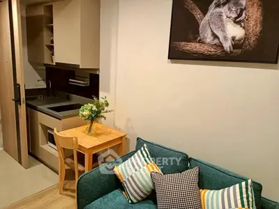 Cozy living room with compact kitchen and stylish decor in modern apartment.