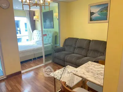 Cozy living room with elegant decor and adjacent bedroom view