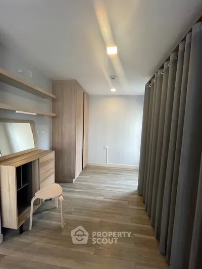 Spacious modern study room with wooden flooring and stylish furniture