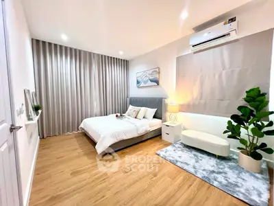 Spacious modern bedroom with elegant decor and cozy ambiance, featuring a comfortable bed and stylish furnishings.