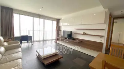 Spacious modern living room with sleek furniture and large windows for natural light.