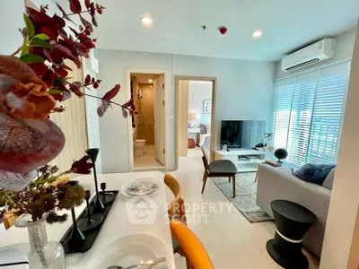 Modern living room with stylish decor and open layout, featuring a cozy seating area and natural light.