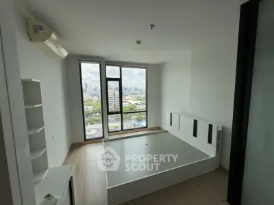 Modern bedroom with large windows offering stunning city views and minimalist design.