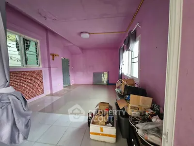Spacious living room with vibrant purple walls and large windows, ideal for creative interior design.