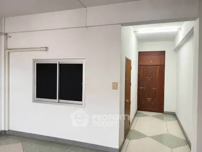 Spacious interior hallway with modern door and window, ideal for customization.