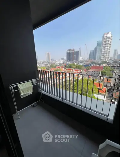 Spacious balcony with stunning city view in modern high-rise apartment.