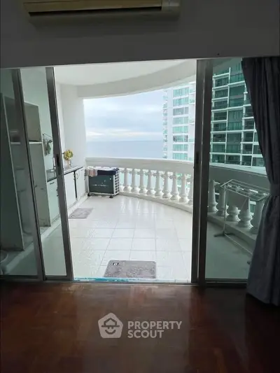 Spacious balcony with ocean view in modern high-rise apartment