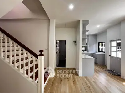 Modern interior with elegant staircase and open kitchen layout