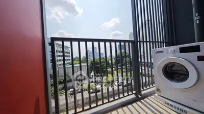 Modern balcony with city view and washing machine, perfect for urban living.