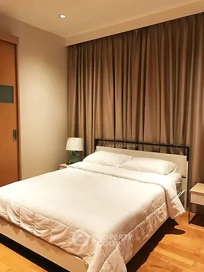 Cozy bedroom with elegant curtains and modern furnishings in a stylish apartment.