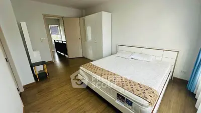 Spacious bedroom with modern decor and wooden flooring