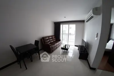 Modern living room with sleek furniture and balcony access in a stylish apartment.