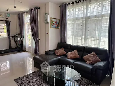 Spacious living room with modern decor and large windows for natural light