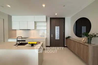 Modern kitchen with sleek white cabinetry and island, featuring a stylish open layout and contemporary decor.