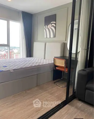 Modern bedroom with stylish decor and large window offering city views.
