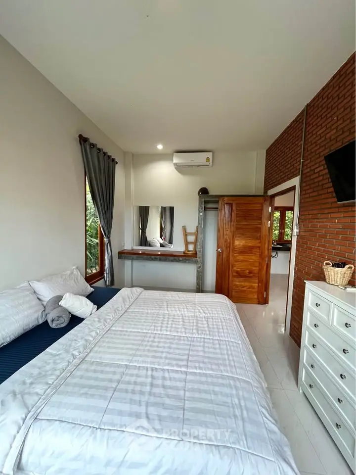 Spacious bedroom with modern decor and natural light