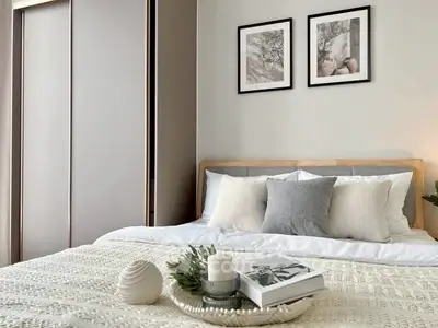 Modern bedroom with cozy decor and stylish artwork on the wall.