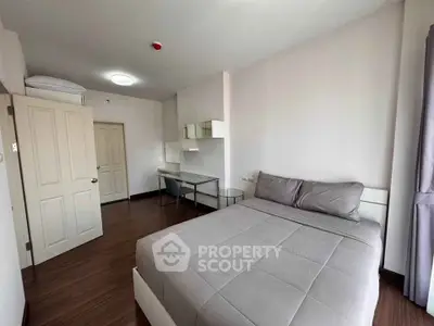 Modern bedroom with sleek design and cozy atmosphere, featuring a comfortable bed and stylish workspace.