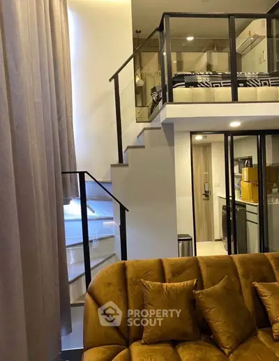 Modern loft apartment with stylish mezzanine and cozy living area, featuring elegant furnishings and contemporary design.