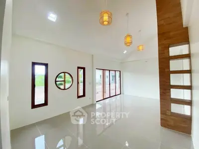 Spacious modern living room with large windows and stylish lighting