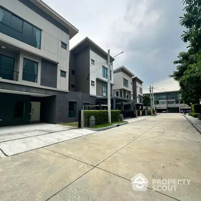 Modern townhouse complex with spacious driveways and lush greenery