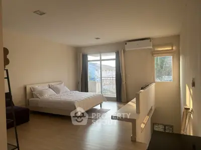 Spacious bedroom with modern decor and natural light