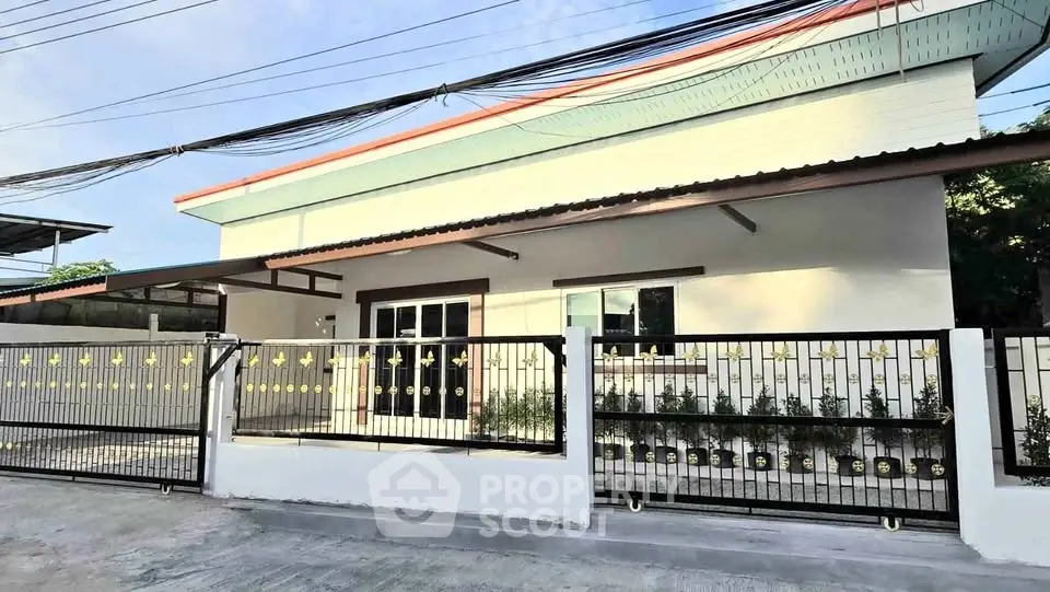 Modern single-story house with stylish fence and spacious driveway
