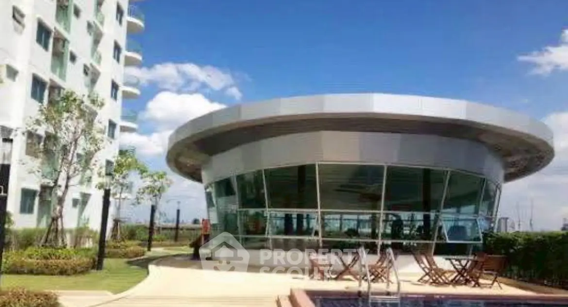 Modern building with pool and garden, ideal for luxury living.