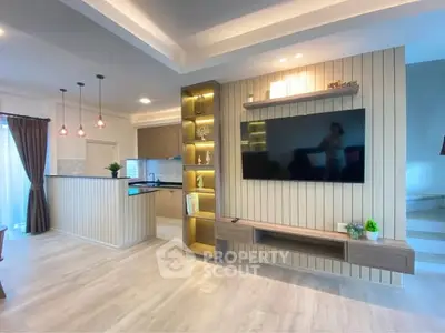 Modern open-plan living room with stylish kitchen and elegant lighting