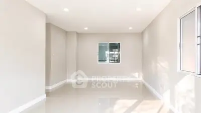 Spacious empty room with large windows and bright natural light, perfect for customization.