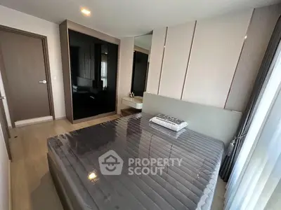 Modern bedroom with sleek design and large mirror wardrobe