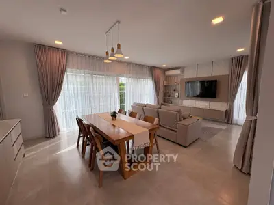 Spacious modern living room with elegant dining area and large windows.