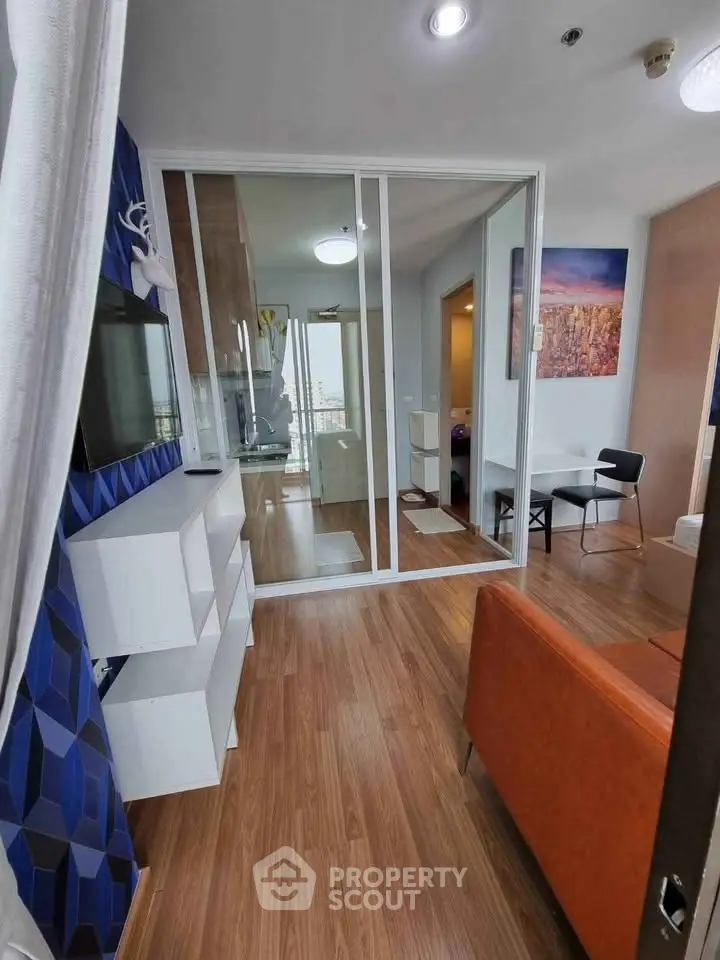 Modern living room with stylish decor and wooden flooring in a contemporary apartment.